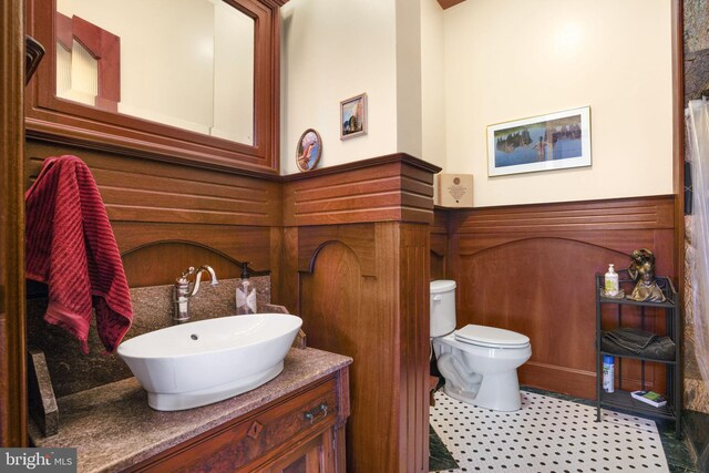 bathroom featuring toilet, vanity, and tile patterned floors