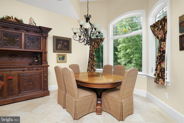 dining room featuring a chandelier and baseboards