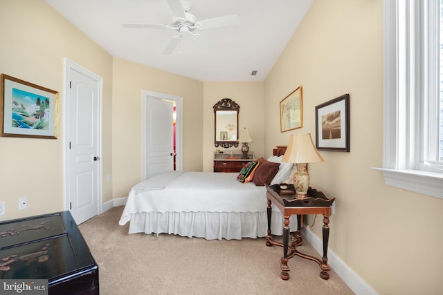 carpeted bedroom with baseboards and a ceiling fan