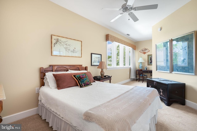 bedroom featuring a ceiling fan, light carpet, and baseboards