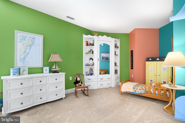 bedroom featuring light carpet and visible vents