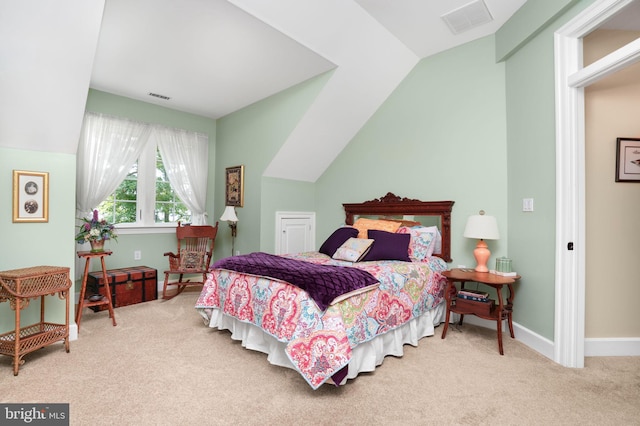 bedroom with carpet, visible vents, lofted ceiling, and baseboards