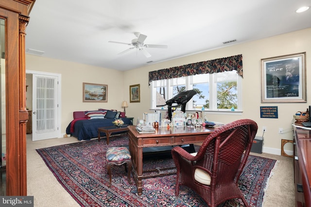 interior space with ceiling fan, light colored carpet, visible vents, and baseboards