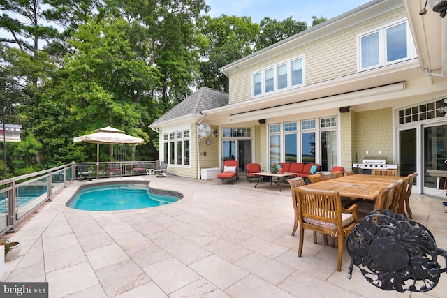 view of pool with a fenced in pool, a patio, a grill, an outdoor living space, and outdoor dining space