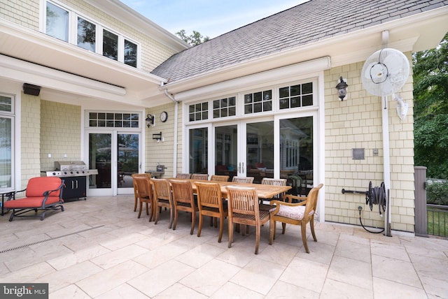 view of patio / terrace featuring a grill, outdoor dining area, and french doors