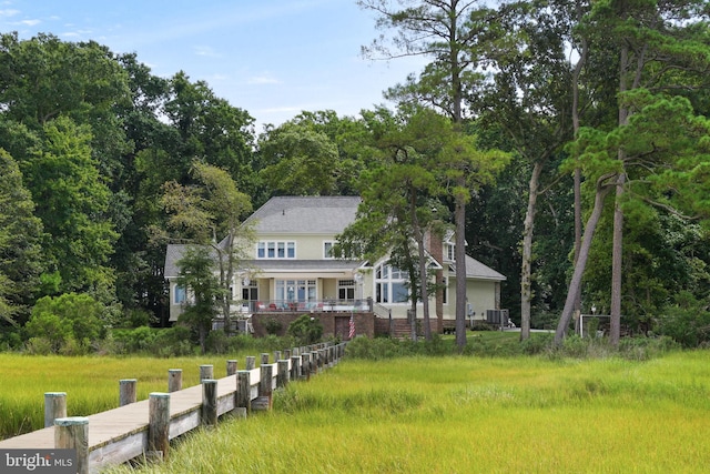 view of front of property with a chimney and central air condition unit