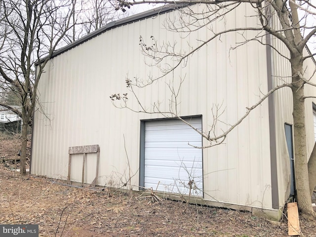 view of home's exterior featuring an outbuilding and a garage