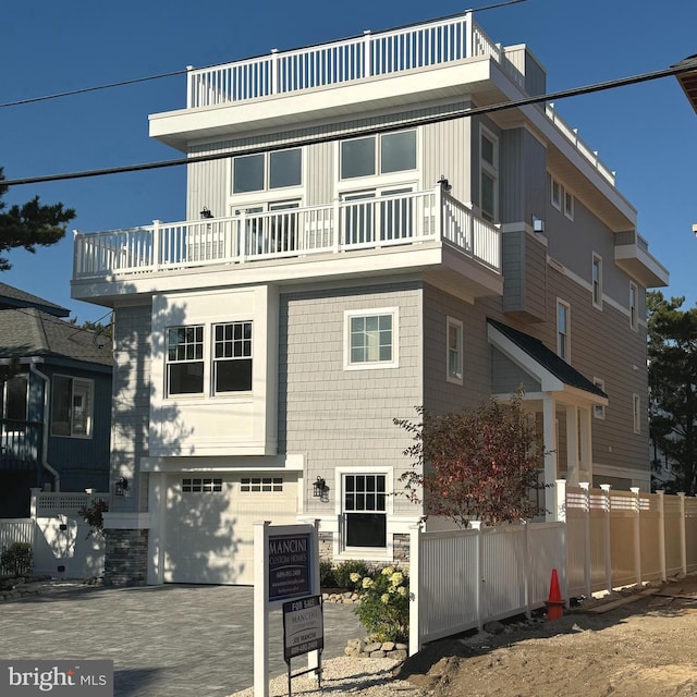 view of front of home featuring a garage and a balcony