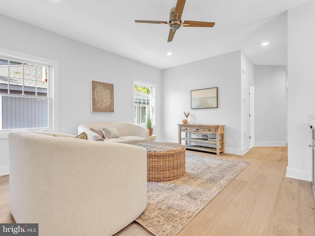 living room with ceiling fan and light wood-type flooring