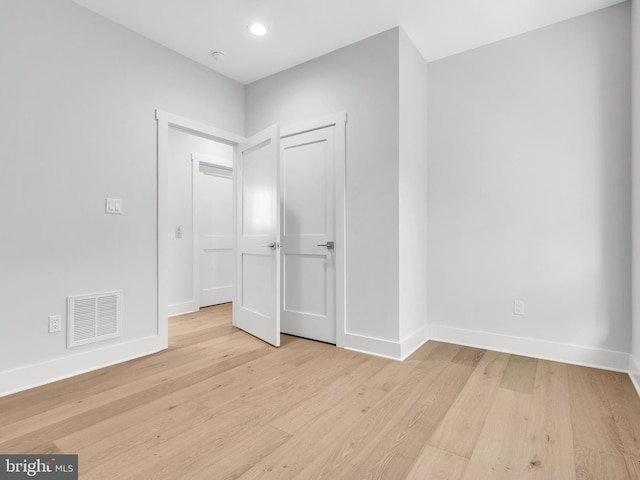 unfurnished bedroom with light wood-type flooring