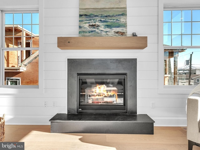 room details featuring hardwood / wood-style flooring and wooden walls