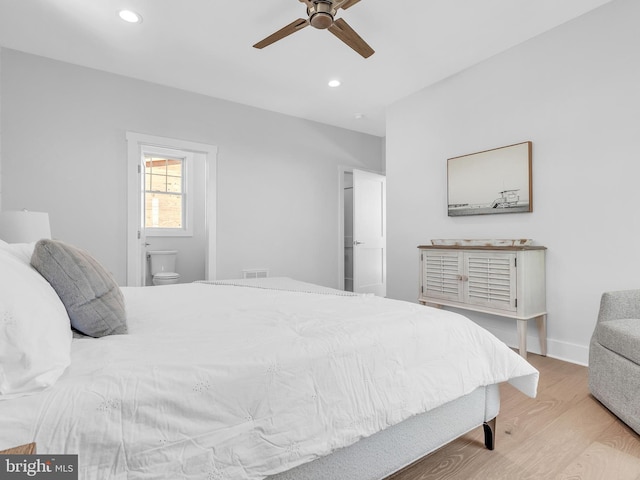 bedroom with ceiling fan, light hardwood / wood-style flooring, and ensuite bathroom