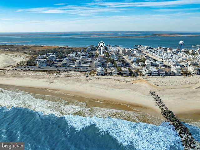 drone / aerial view featuring a water view and a view of the beach