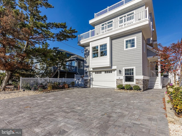 view of front of home featuring a balcony and a garage