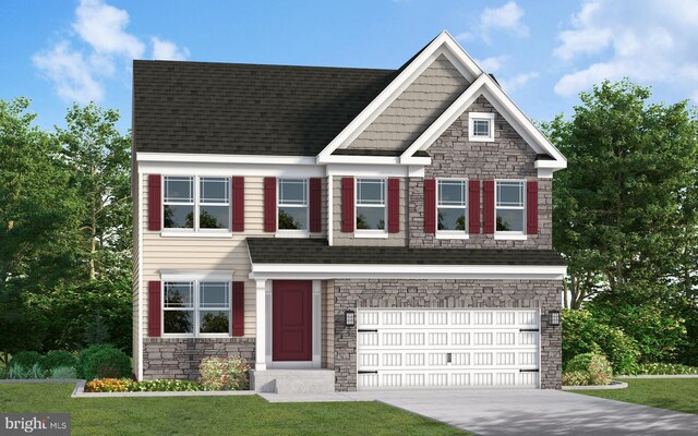 view of front of house with a garage and a front lawn