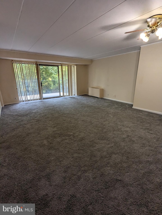 carpeted spare room featuring radiator and ceiling fan