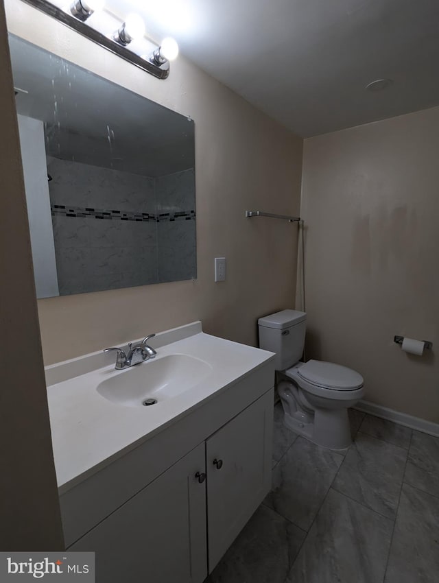 bathroom with vanity, toilet, and tile patterned flooring