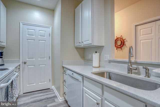 kitchen featuring white cabinetry, light hardwood / wood-style floors, light stone counters, sink, and white appliances