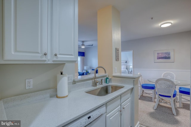 kitchen with white cabinetry, sink, and ceiling fan