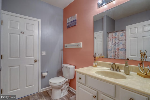 bathroom featuring hardwood / wood-style flooring, vanity, and toilet