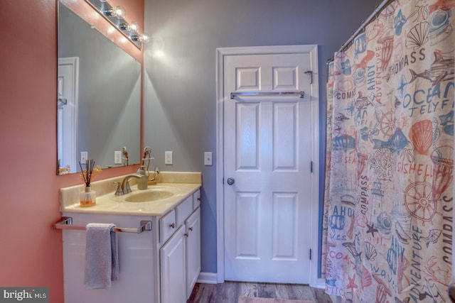 bathroom with hardwood / wood-style flooring and vanity