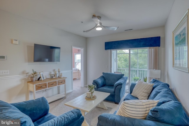 living room with ceiling fan and light colored carpet