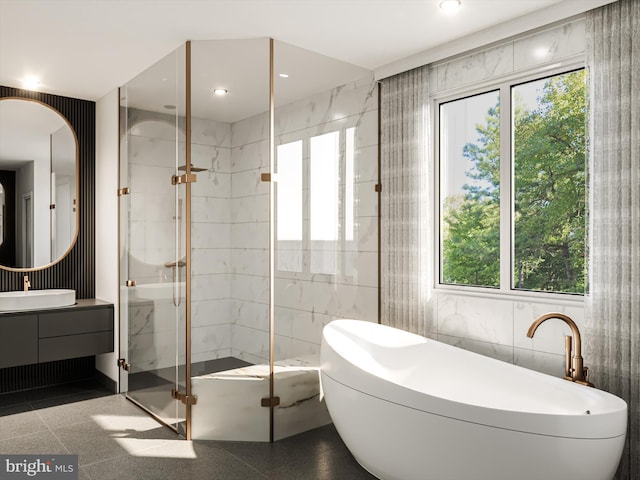 bathroom with a wealth of natural light, tile patterned floors, tile walls, and vanity