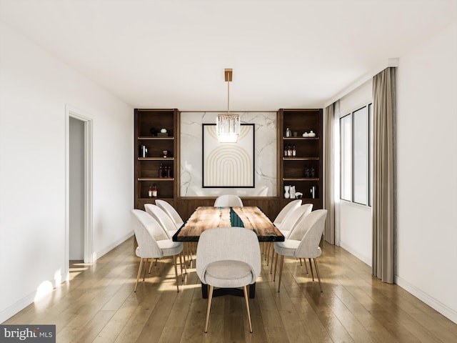 dining room with hardwood / wood-style flooring and a chandelier