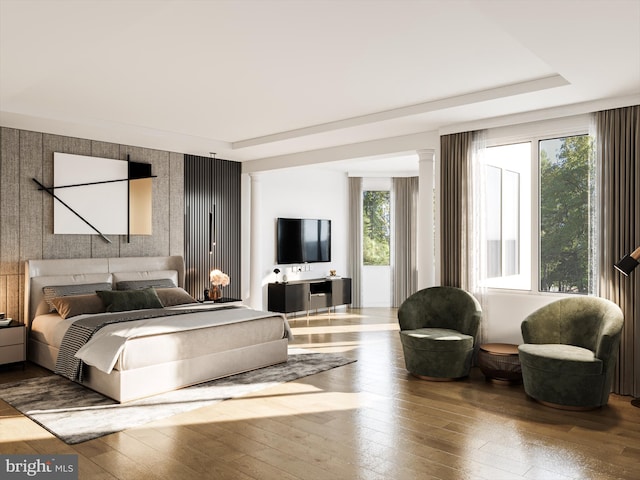 bedroom featuring hardwood / wood-style floors and multiple windows