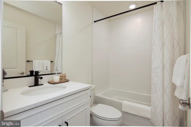 full bathroom featuring vanity, shower / bath combination with curtain, and toilet