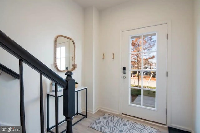 entryway with a healthy amount of sunlight and light hardwood / wood-style floors