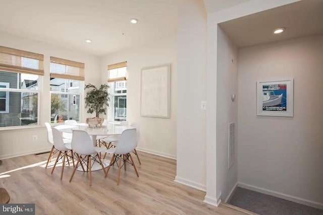 dining space with light hardwood / wood-style flooring