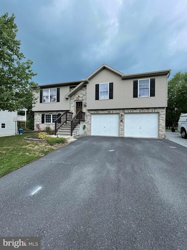 bi-level home with a front lawn and a garage