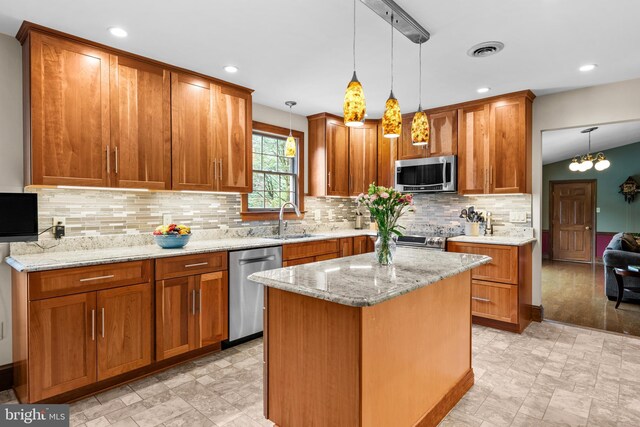 kitchen featuring pendant lighting, light tile patterned flooring, backsplash, stainless steel appliances, and sink