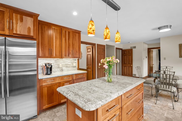 kitchen with tasteful backsplash, a center island, light tile patterned floors, and high quality fridge