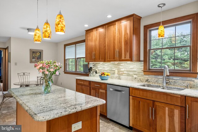 kitchen featuring backsplash, dishwashing machine, a center island, light tile patterned floors, and sink