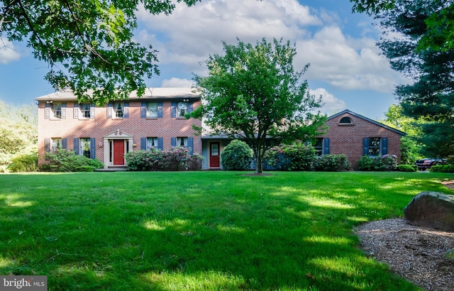 colonial-style house with a front lawn