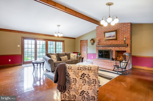 living room with a fireplace, lofted ceiling with beams, brick wall, and an inviting chandelier