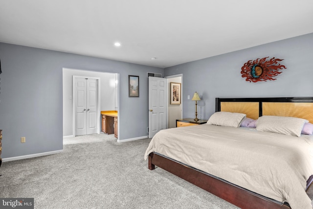 carpeted bedroom with ensuite bathroom