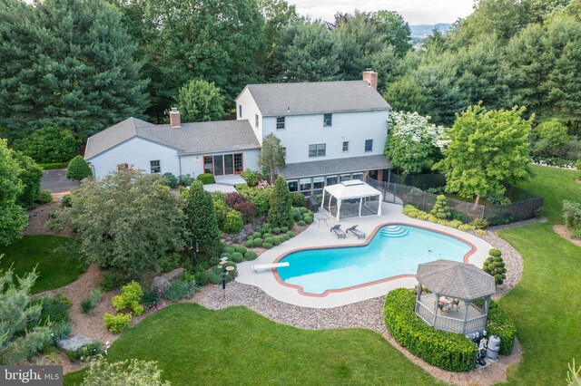 view of swimming pool with a gazebo, a diving board, a patio area, and a yard