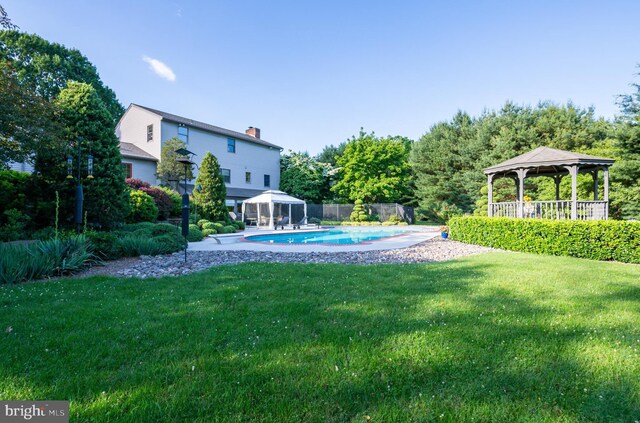 view of yard featuring a fenced in pool and a gazebo