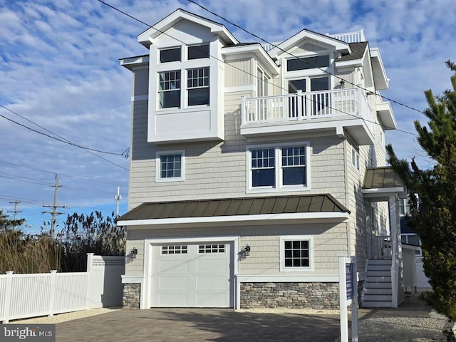 view of front of property with a balcony and a garage