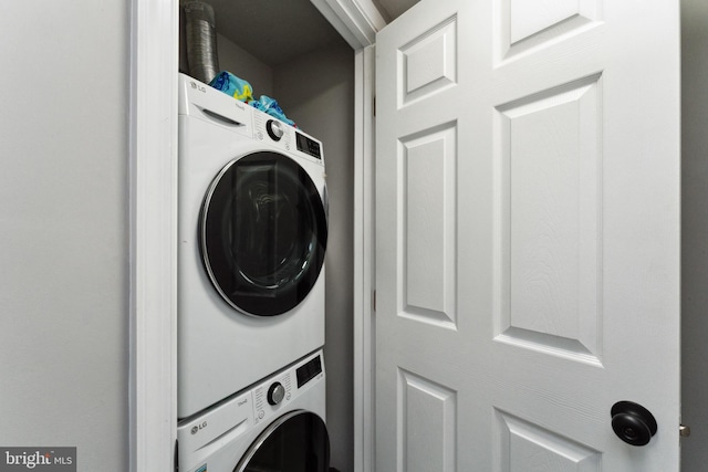 laundry area with stacked washing maching and dryer