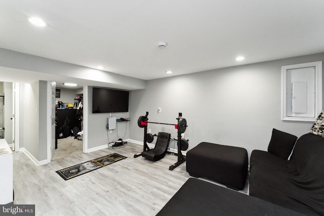 workout area with light hardwood / wood-style flooring