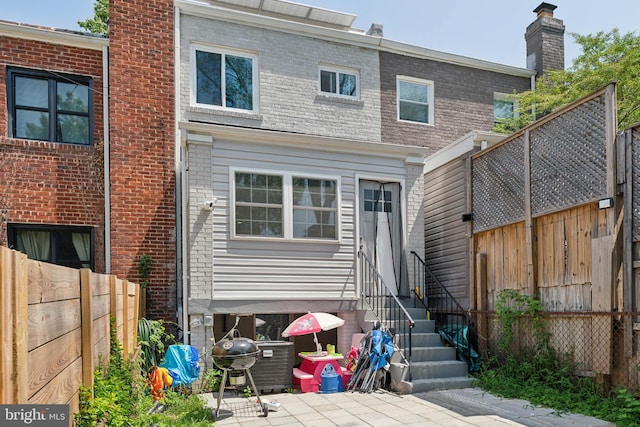 rear view of property featuring a patio