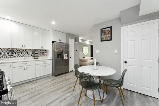 dining space featuring light wood-type flooring