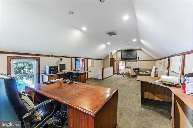 home office with vaulted ceiling and light colored carpet