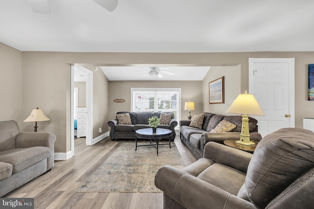 living room with a ceiling fan, light wood-type flooring, and baseboards