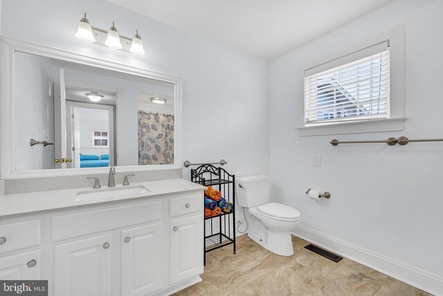 bathroom with tile patterned flooring, toilet, and vanity