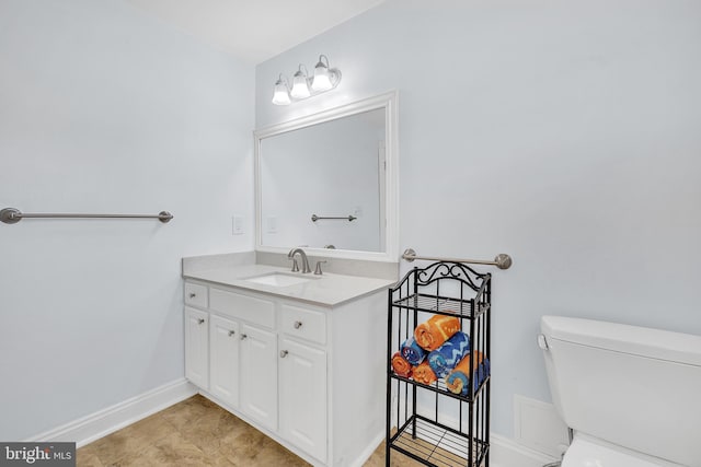 bathroom featuring toilet, tile patterned flooring, and vanity